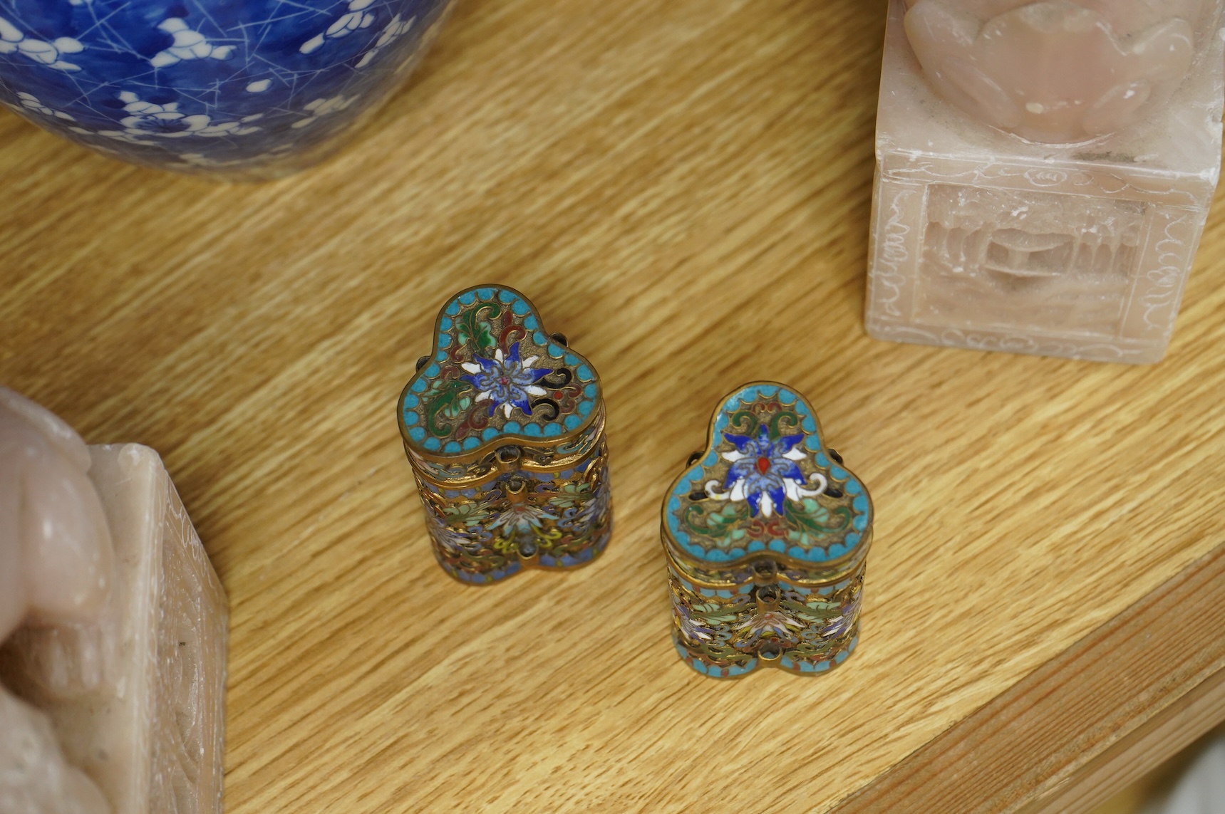 A pair of Chinese soapstone lion-dogs - 22.5cm high, two cloisonné enamel boxes and covers and a blue & white jar & cover